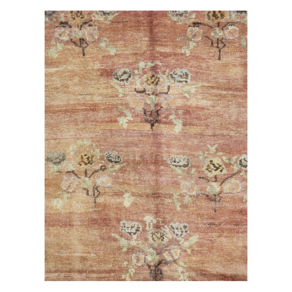 A vintage Turkish Anatolian accent rug in gallery format handmade during the mid-20th century. The floral rose bouquets were inspired by early European designs.

Measures: 5'0