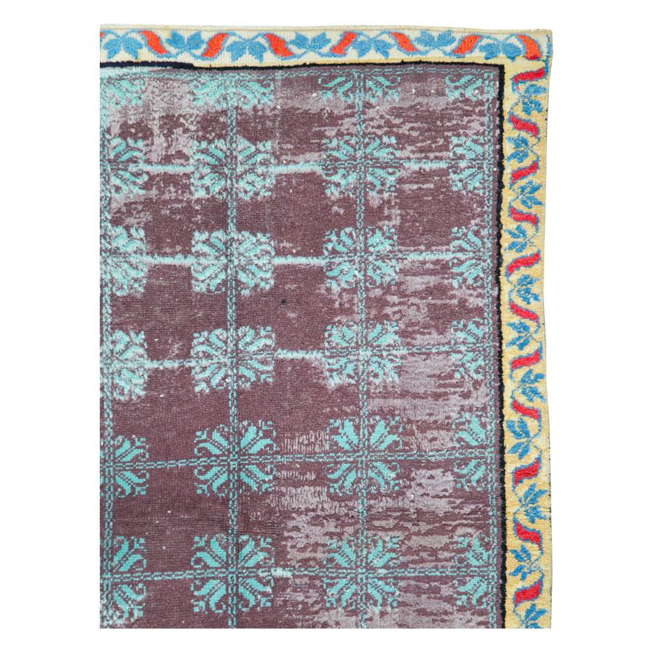A vintage Indian Cotton Agra throw rug handmade during the mid-20th century with a contemporary design in shades of purple, blue, red, and straw-yellow.

Measures: 3' 2