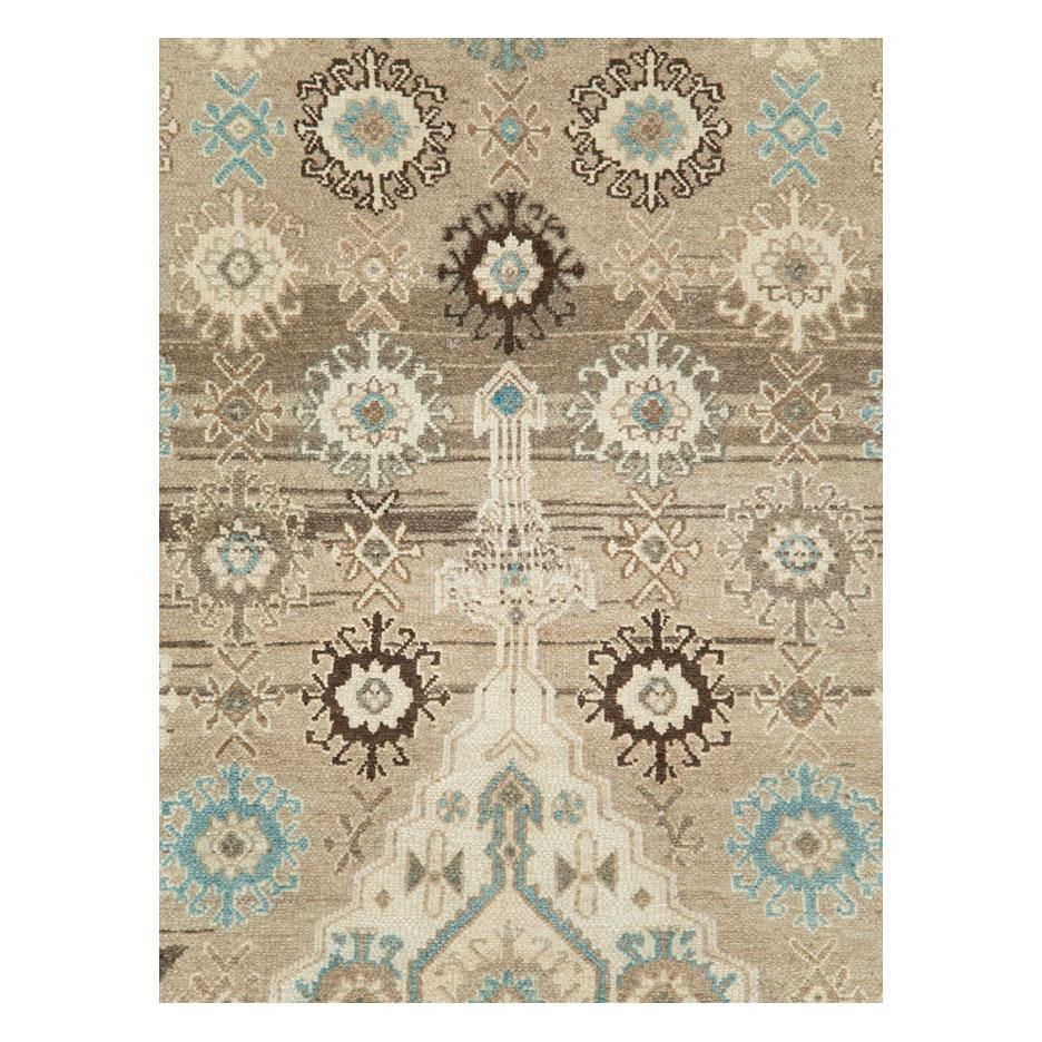 A vintage Persian Bibikabad room size rug handmade during the mid-20th century predominantly light brown with slate blue accents, and a cream medallion and corner spandrels.

Measures: 8'9