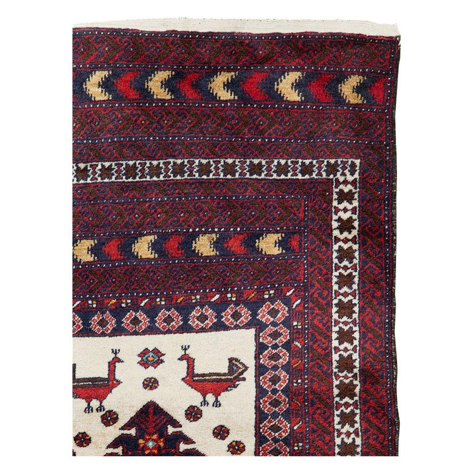 A vintage Persian Baluch throw rug handmade during the mid-20th century.

Measures: 3' 5