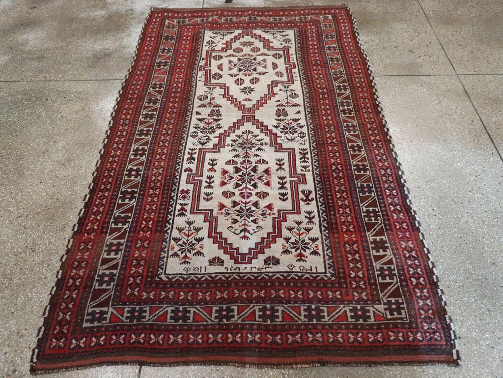 A vintage Persian Baluch tribal accent rug handmade during the mid-20th century.

Measures: 4' 5