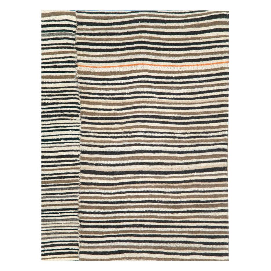 A vintage Persian flat-weave Kilim zebra print small room size accent rug handmade during the mid-20th century in the rustic style that works well with modern farmhouse interiors.

Measures: 6' 5