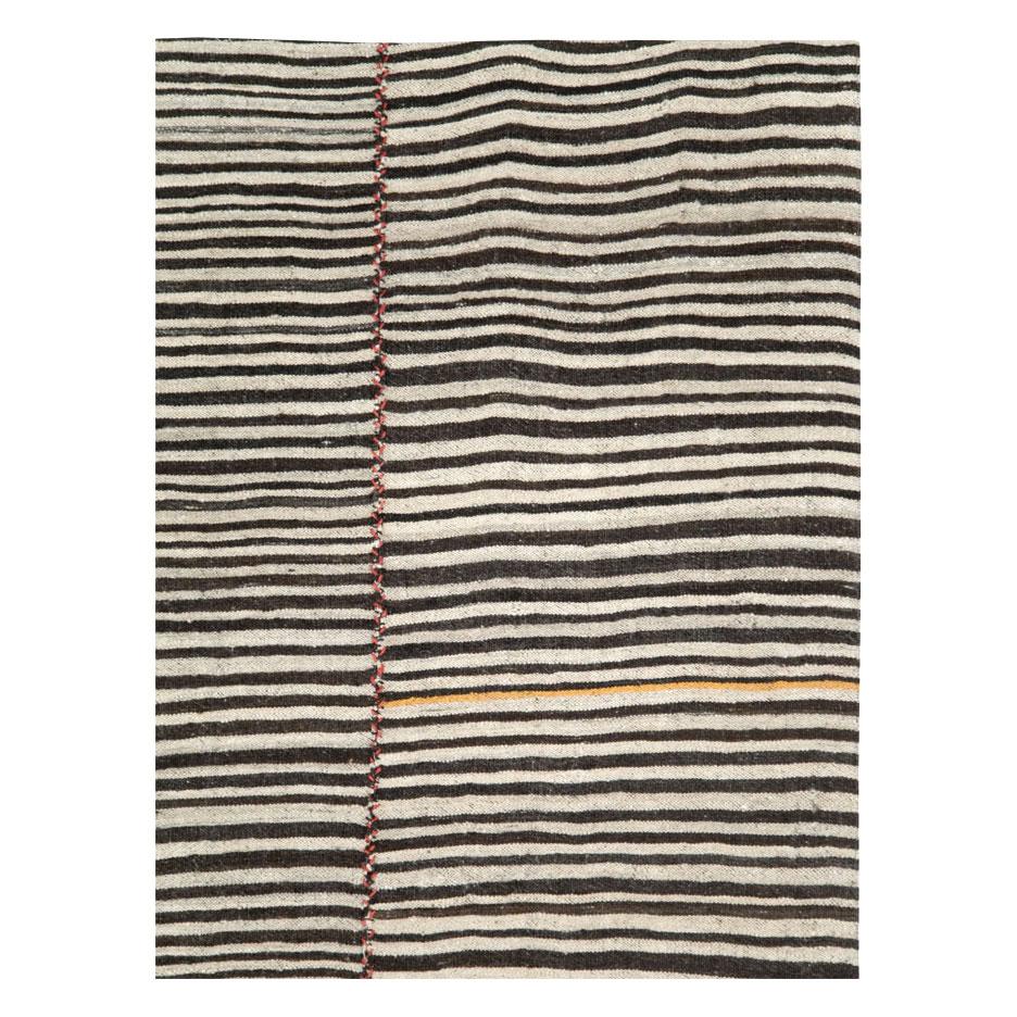 A vintage Persian flat-weave Kilim zebra print small room size accent rug handmade during the mid-20th century in the rustic style that works well with modern farmhouse interiors.

Measures: 6' 3