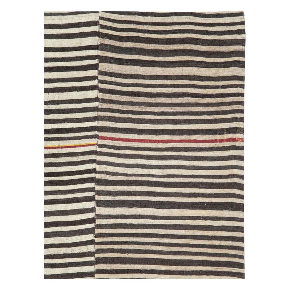 A vintage Persian flat-weave Kilim zebra print small room size accent rug handmade during the mid-20th century in the rustic style that works well with modern farmhouse interiors.

Measures: 6' 8