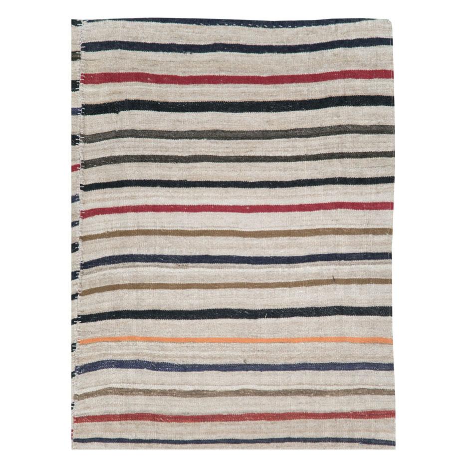 A vintage Persian flat-weave Kilim zebra print small room size accent rug handmade during the mid-20th century. Black and cream stripes, among other shades, create the rustic style that works well with modern farmhouse interiors.

Measures: 4' 9