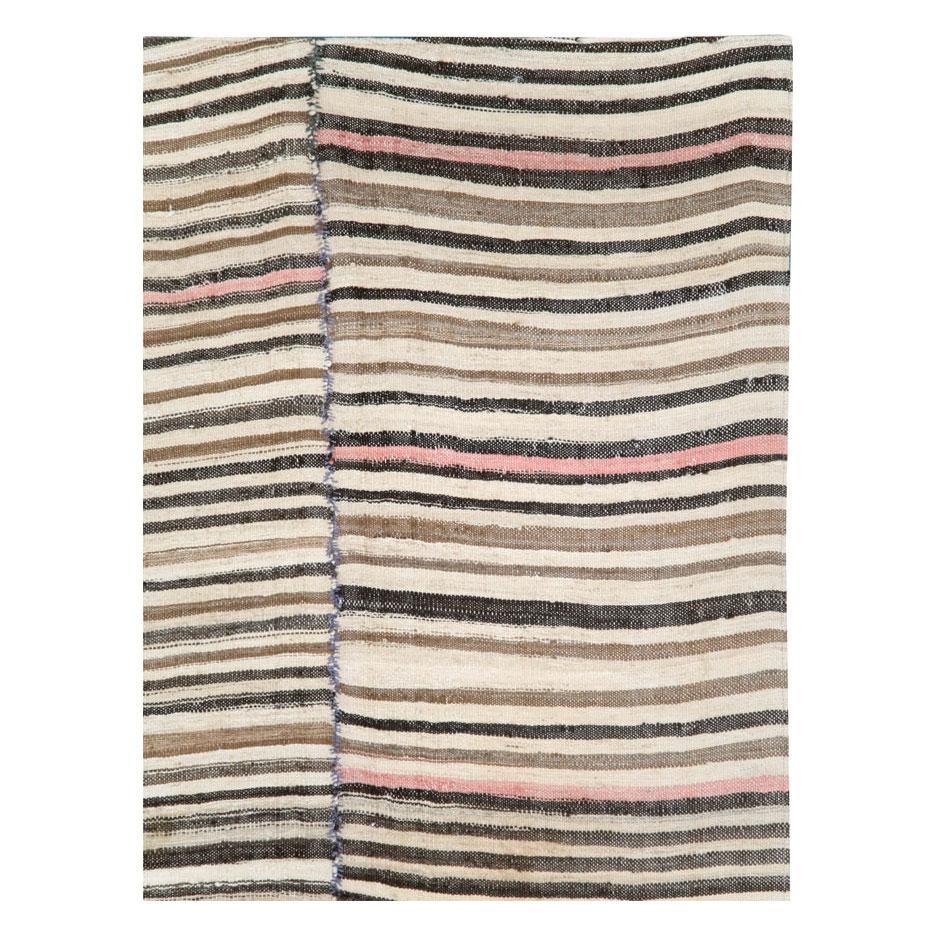 A vintage Persian flat-weave Kilim zebra print small room size accent rug handmade during the mid-20th century. Black, brown, and cream stripes, among other shades, create the rustic style that works well with modern farmhouse
