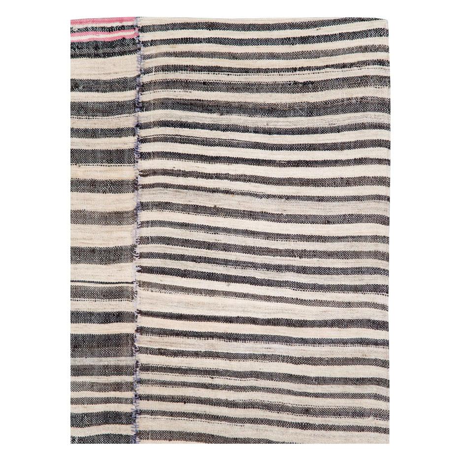 A vintage Persian flat-weave Kilim zebra print small room size accent rug handmade during the mid-20th century. Black, brown, and cream stripes, among other shades, create the rustic style that works well with modern farmhouse