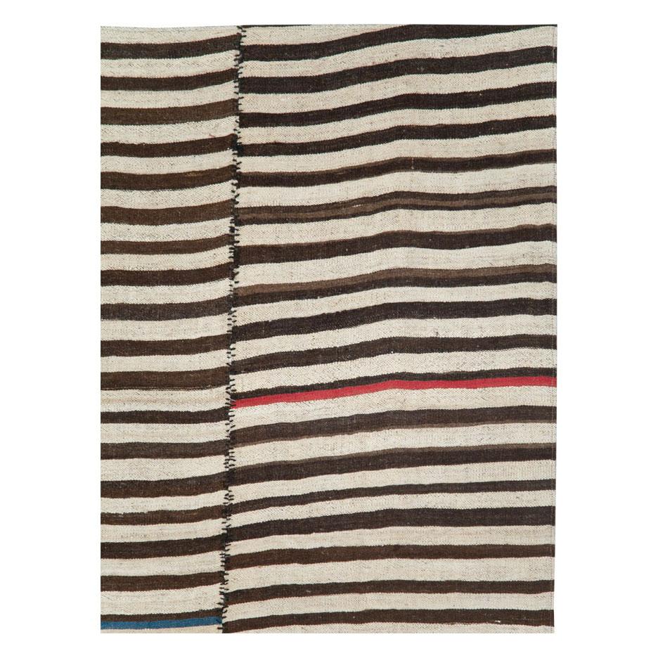 A vintage Persian flatweave Kilim accent rug handmade during the mid-20th century with a striped zebra print pattern.

Measures: 5' 3