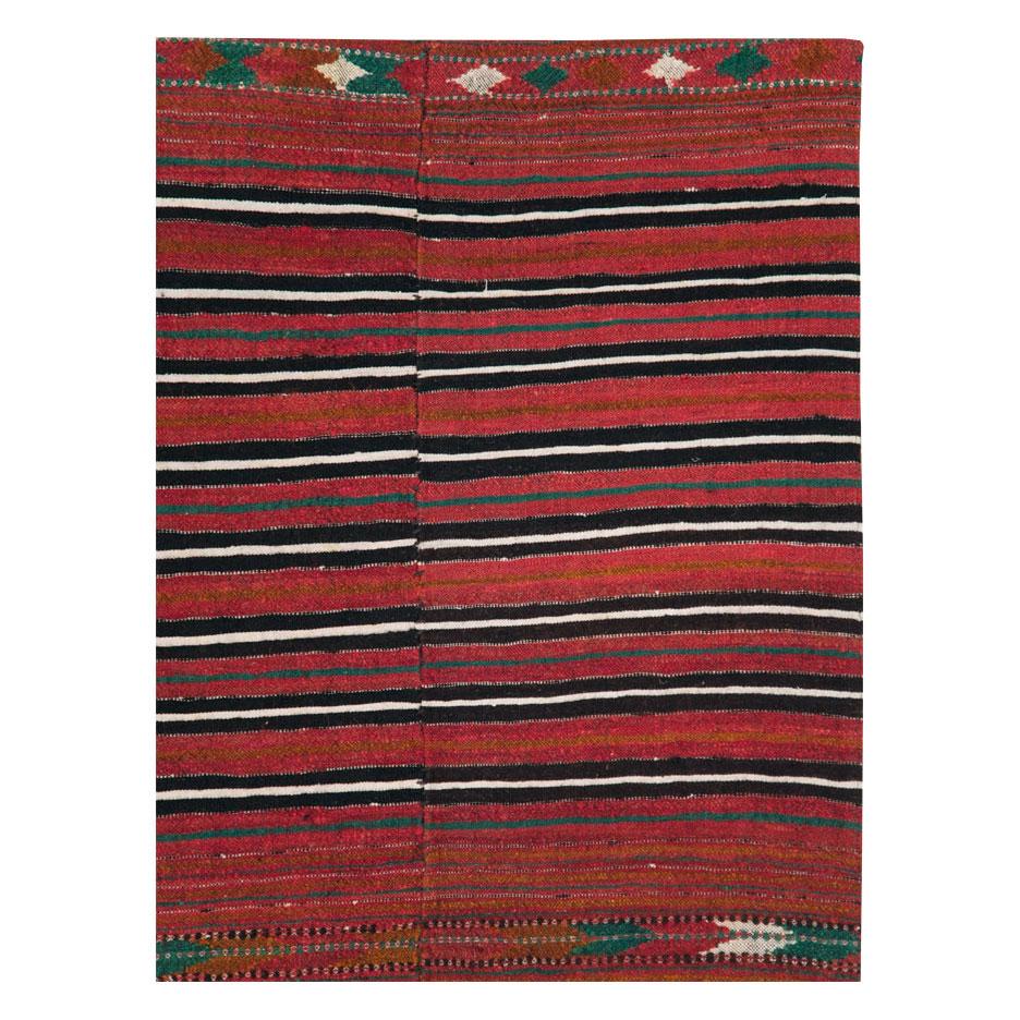 A vintage Persian flatweave Kilim accent rug handmade during the mid-20th century.

Measures: 4' 6
