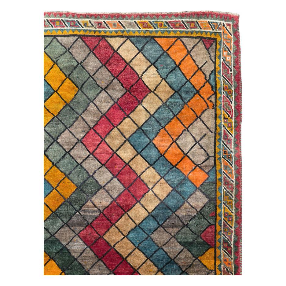 A vintage Persian Gabbeh accent rug handmade during the mid-20th century.

Measures: 4' 0