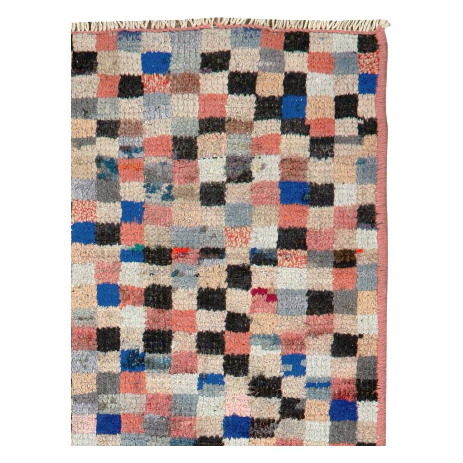 A vintage Persian Gabbeh throw rug handmade during the mid-20th century with a contemporary checkerboard design.

Measures: 1' 10