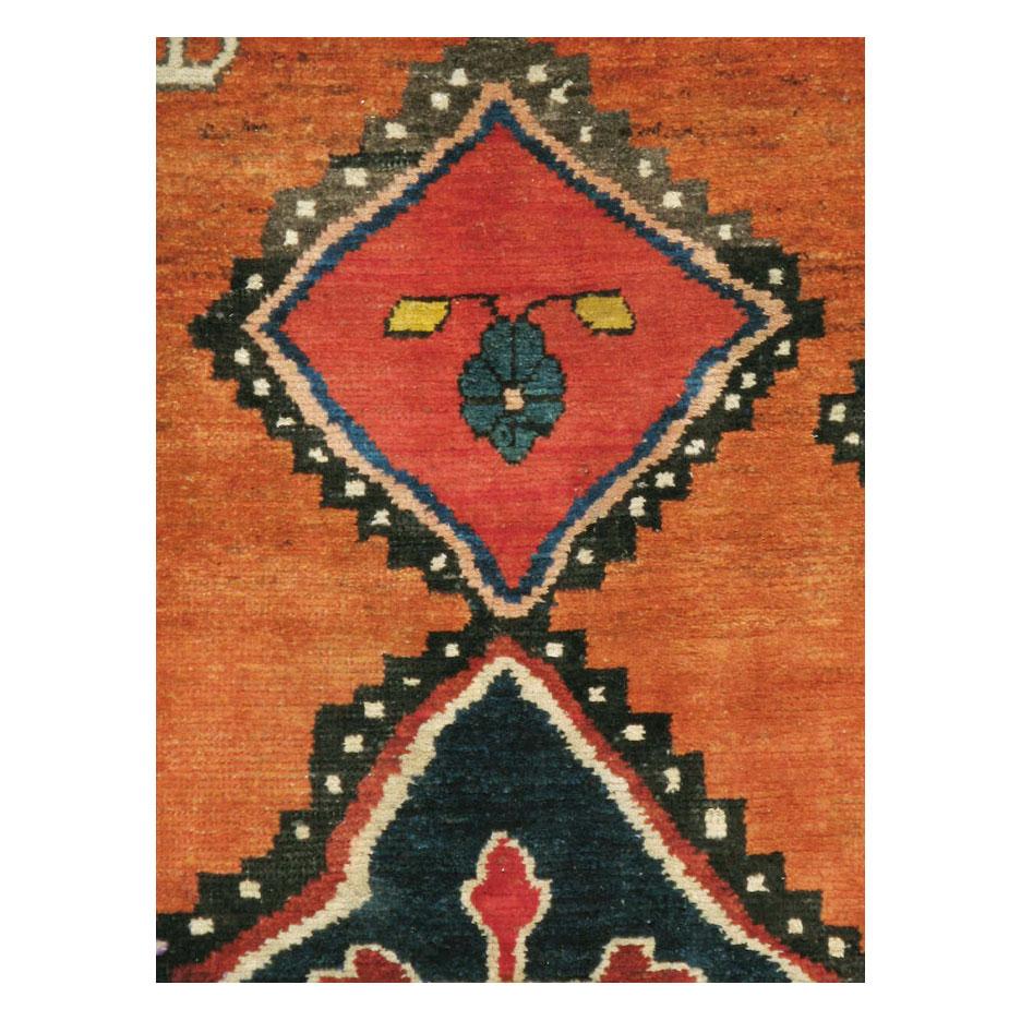 A vintage Persian Gabbeh tribal accent rug handmade during the mid-20th century.

Measures: 5' 8