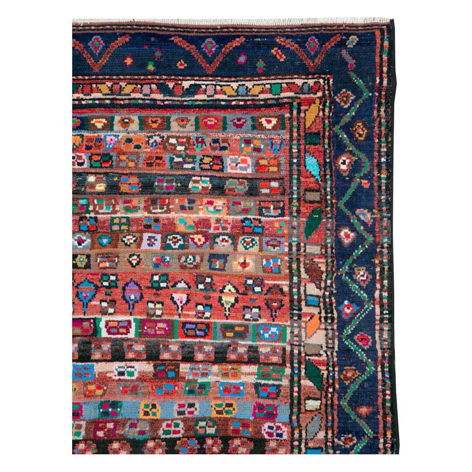 A vintage Persian Hamadan small accent rug handmade during the mid-20th century.

Measures: 3' 5