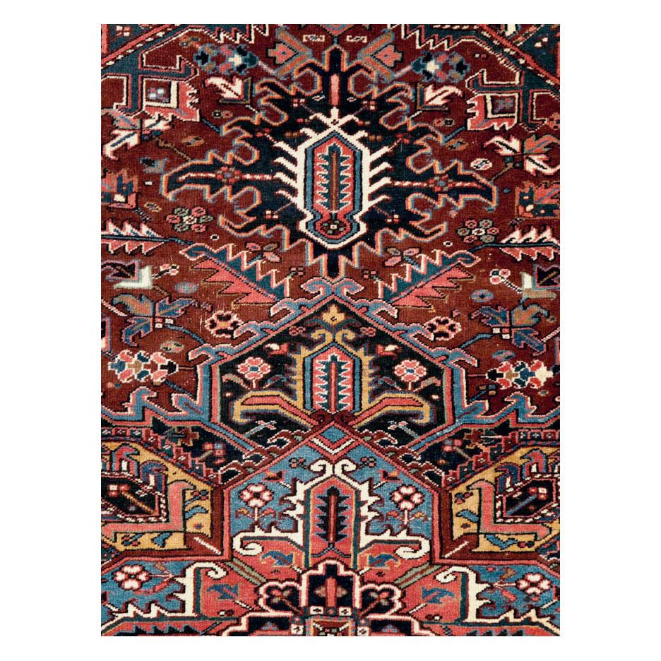 A vintage Persian Heriz room size carpet handmade during the mid-20th century.

Measures: 8' 11
