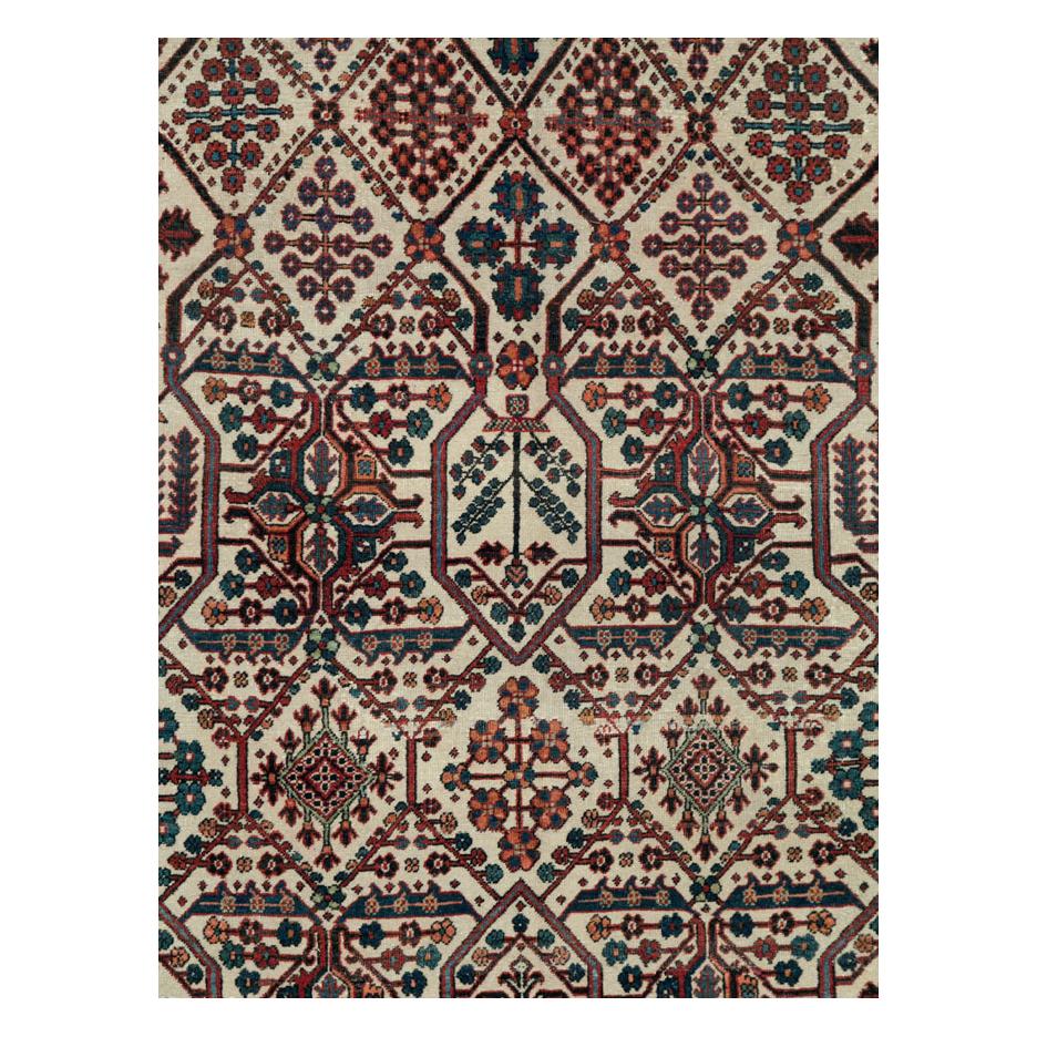 A vintage Persian Joshegan room size carpet handmade during the mid-20th century in cream and red.
