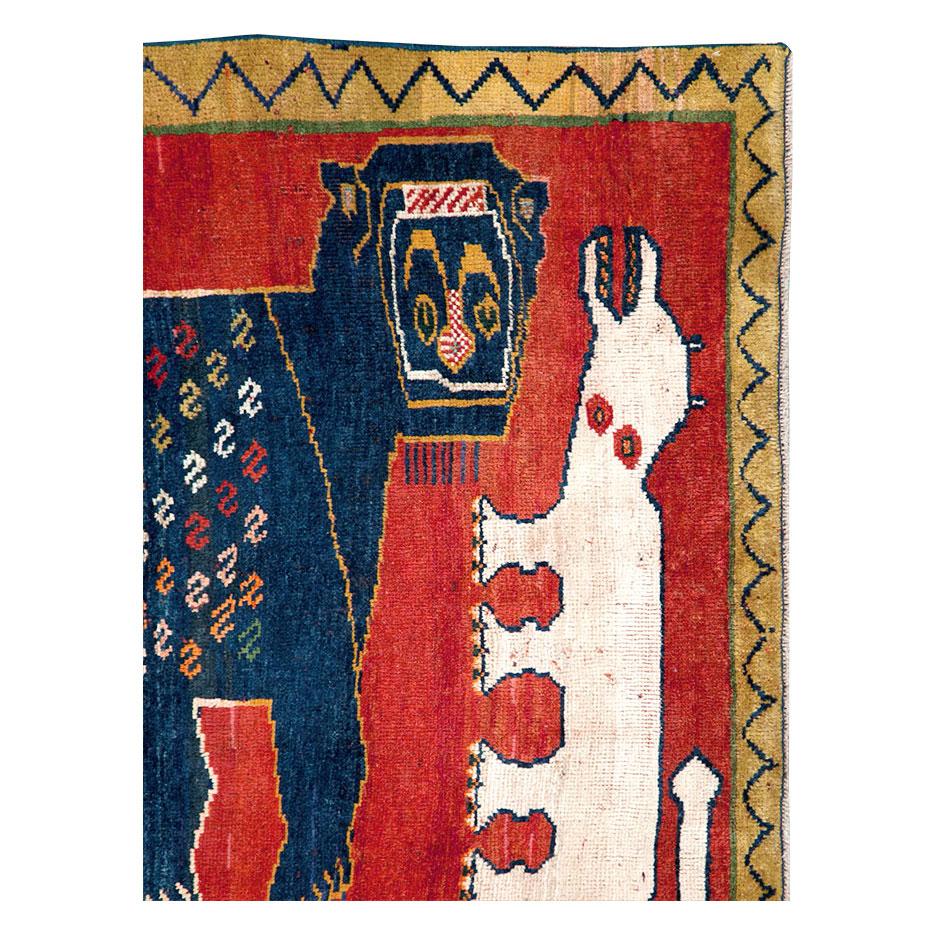 A vintage Persian pictorial Shiraz throw rug handmade during the mid-20th century.

Measures: 3' 9