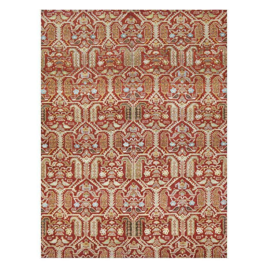 A vintage Persian Quom accent rug handmade during the mid-20th century with a rust-red field and slate to bluish-green border.

Measures: 7' 0