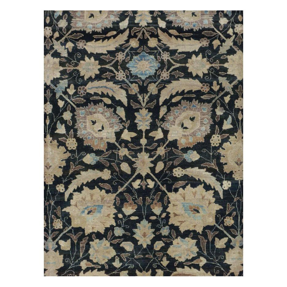 A vintage Persian Tabriz room size carpet handmade during the mid-20th century with a sickle leaf and vine scroll design over a black field. This classic pattern can also be found on the 17th century Persian carpet that is considered the most
