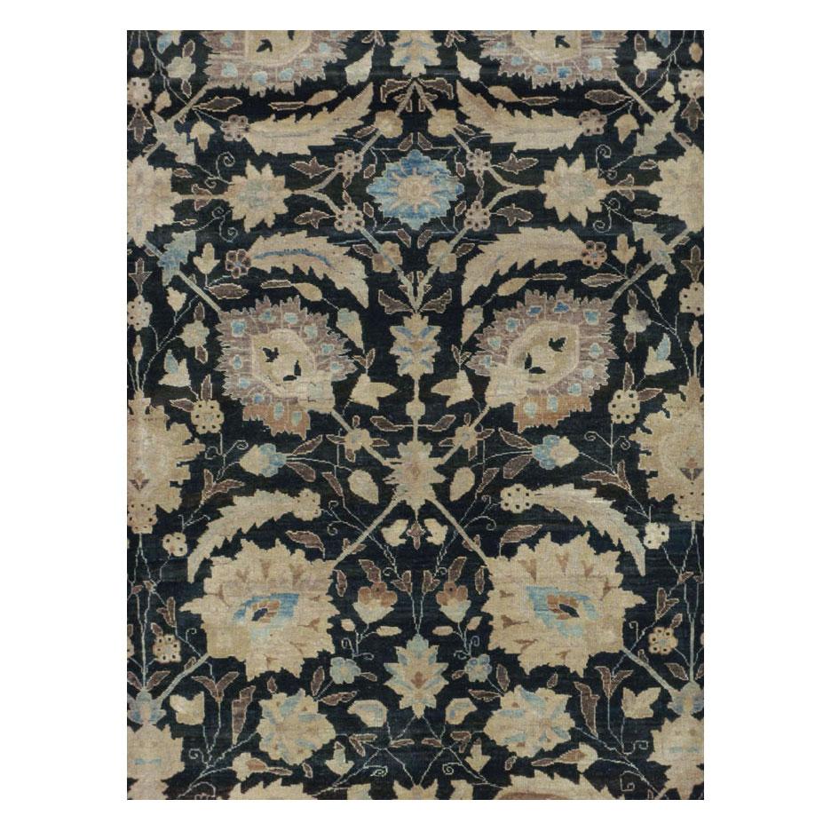 A vintage Persian Tabriz room size carpet handmade during the mid-20th century with a sickle leaf and vine scroll design over a black field. This classic pattern can also be found on the 17th century Persian carpet that is considered the most