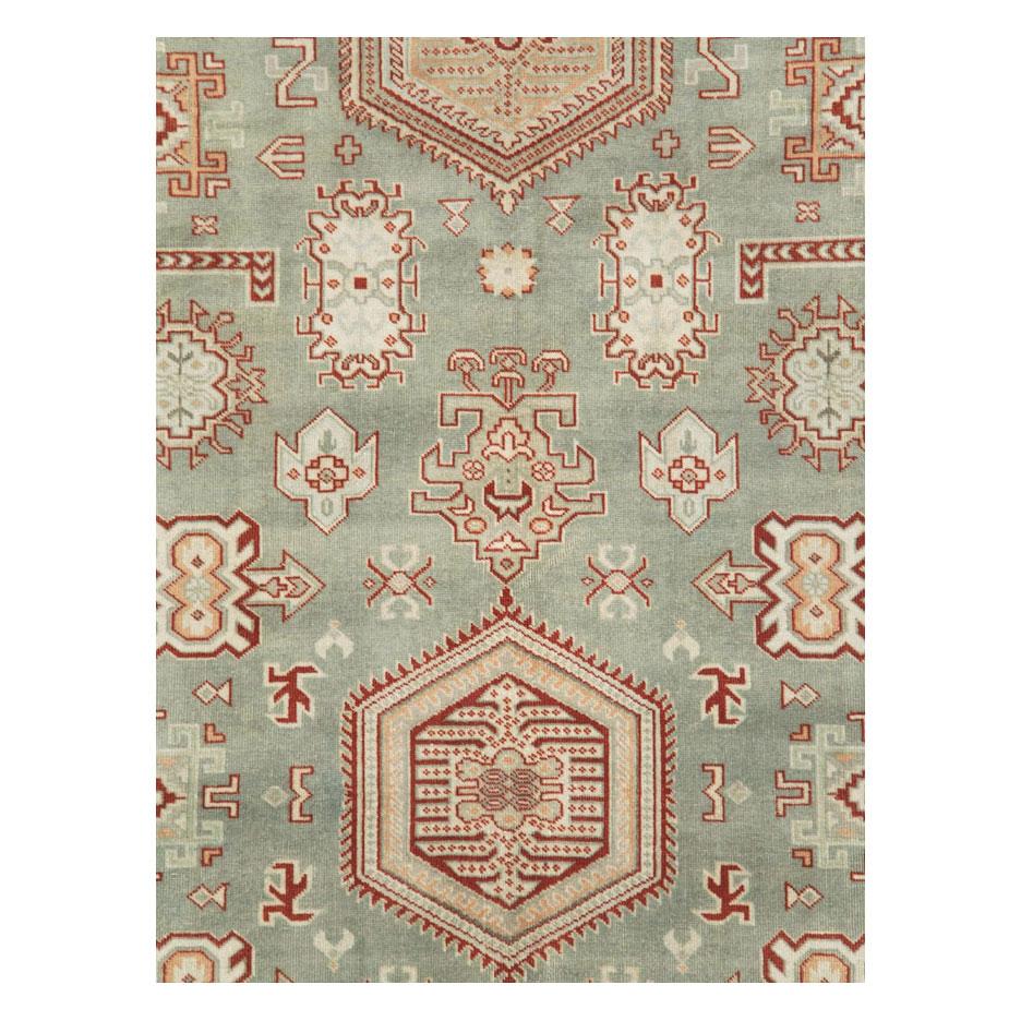 A vintage Persian Tabriz accent rug handmade during the mid-20th century with a green field and rust red border. The Tabriz weavers of this rug took one directly from the design repertoire of the Persian Karajeh weavers.

Measures: 6'2