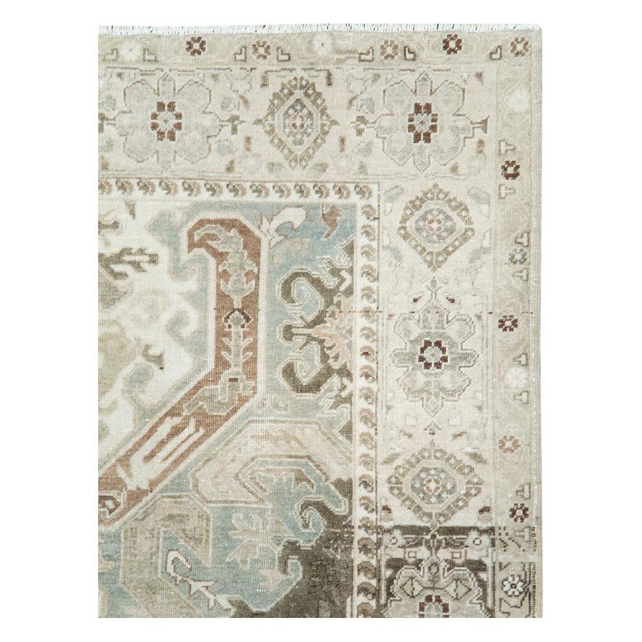 A vintage Persian Tabriz accent rug with a bold medallion handmade during the mid-20th century in shades of grey and cream.

Measures: 5' 6