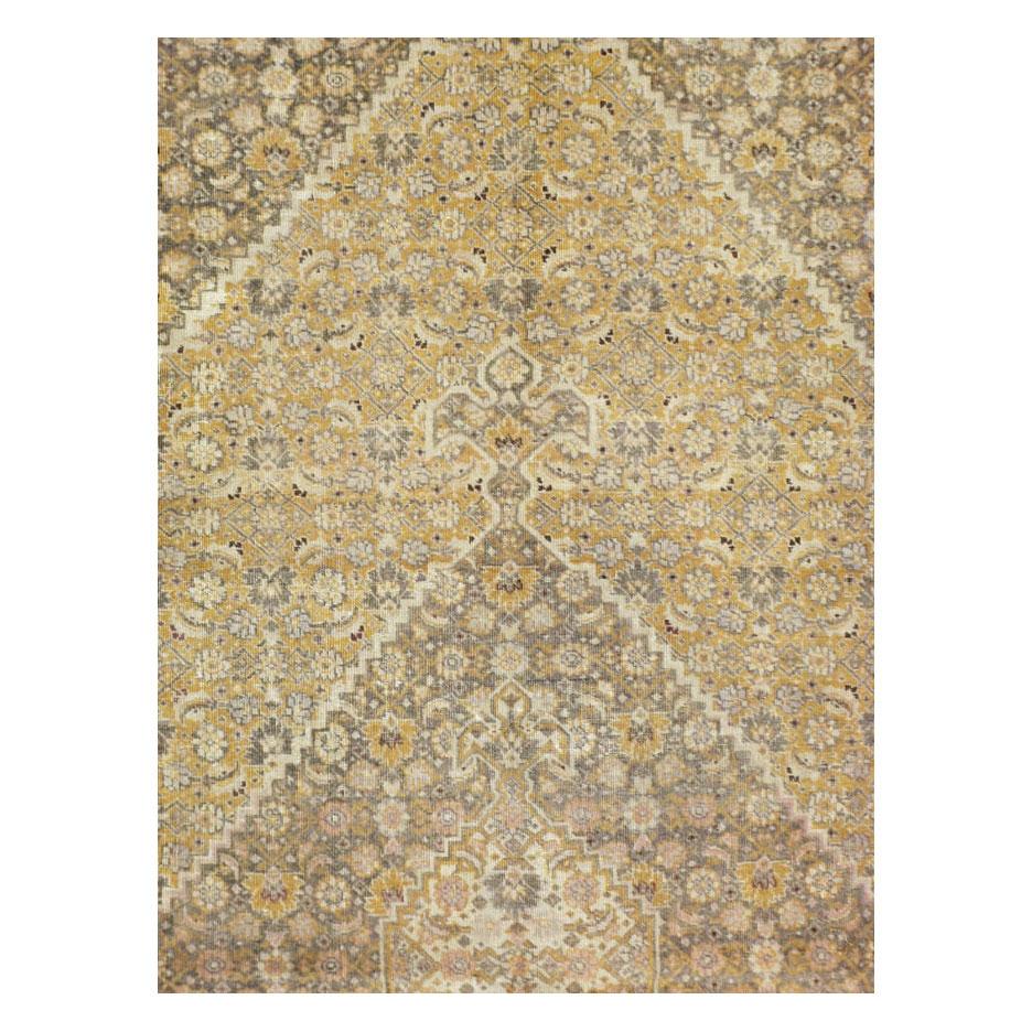 A vintage Persian Tabriz large room size carpet handmade during the mid-20th century with a large geometric stepped lattice filled in with a double pendant stepped lattice. The entire field is filled with a perfectly proportioned classic Persian