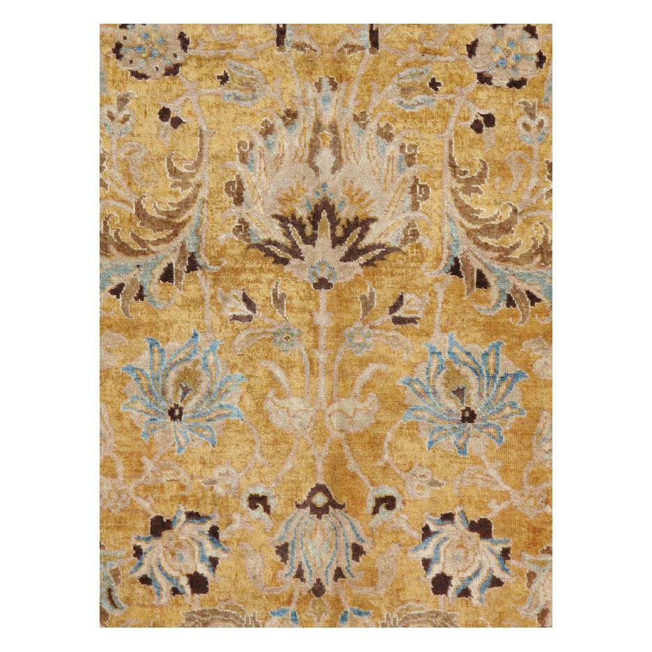 A vintage Persian Tabriz room size carpet handmade during the mid-20th century with a well-drawn floral design over a yellow goldenrod field and bordered in blush.

Measures: 8' 6