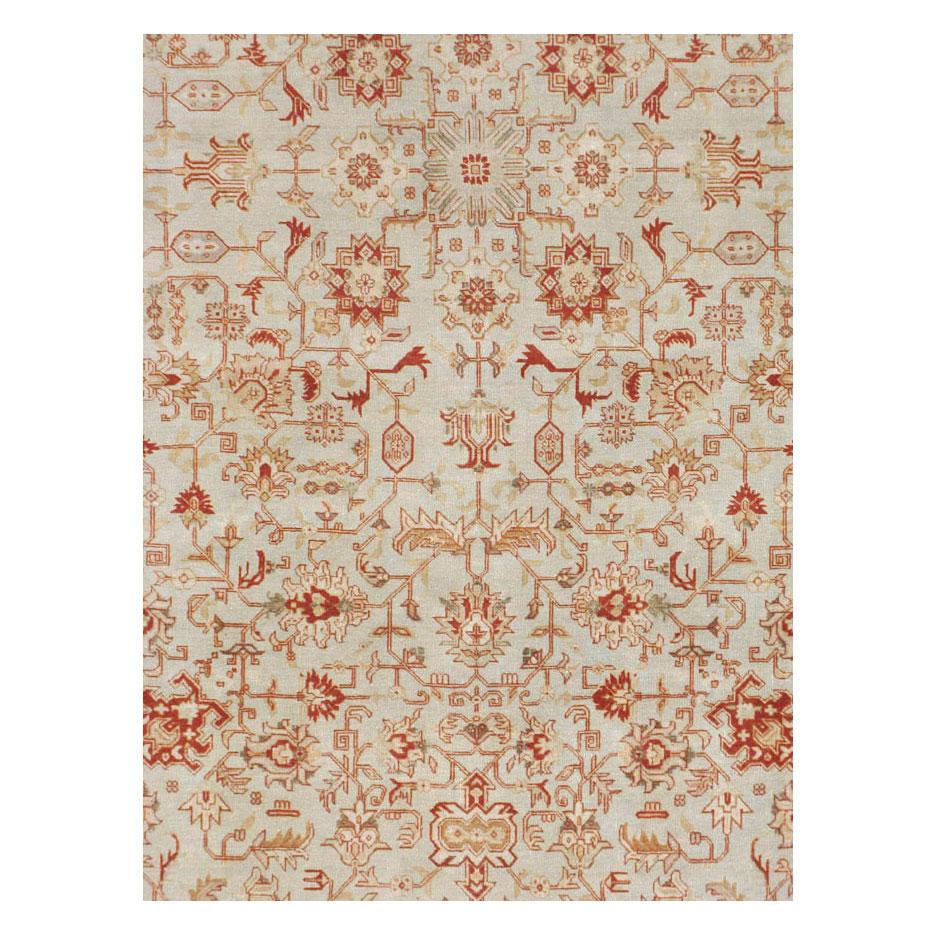 A vintage Persian Tabriz room size carpet handmade during the mid-20th century with a grey field and rust red border.

Measures: 9' 5