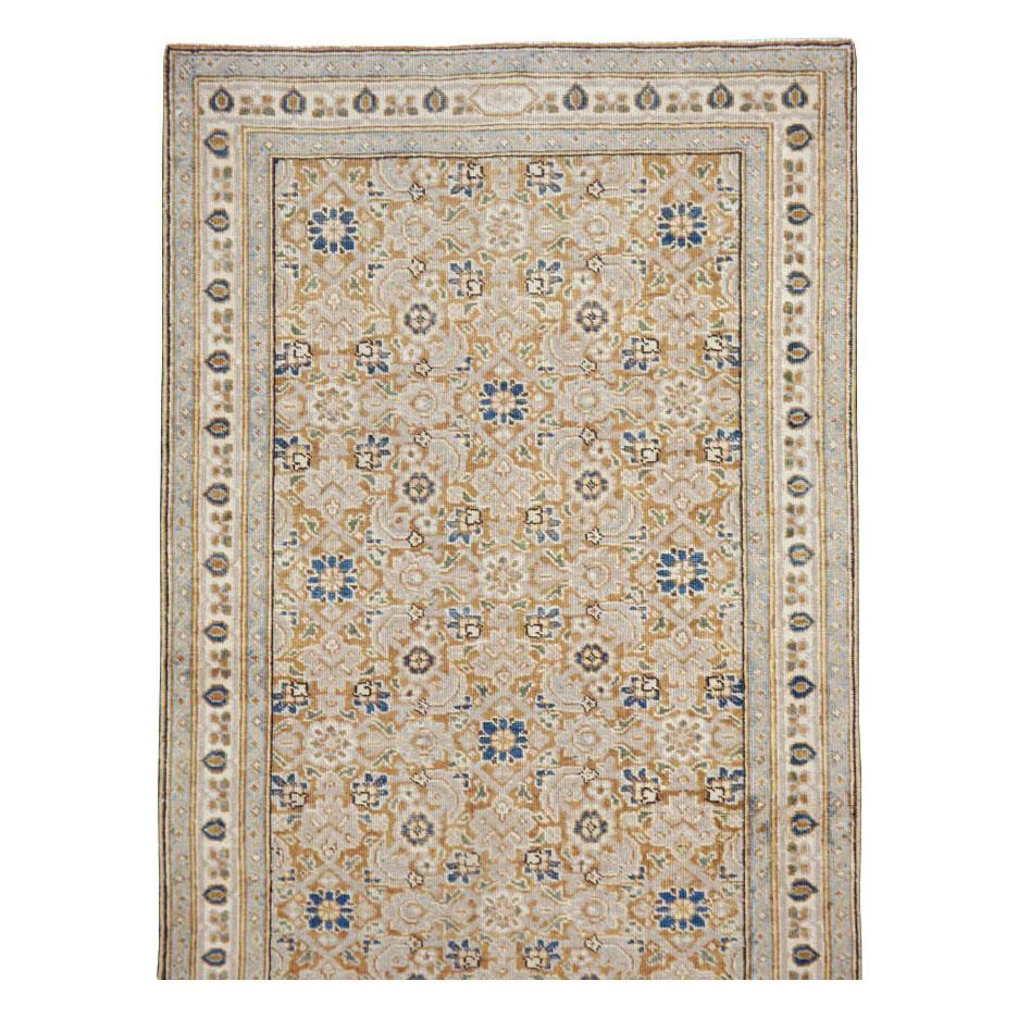 A vintage Persian Tabriz rug in runner format handmade during the mid-20th century.

Measures: 2' 11