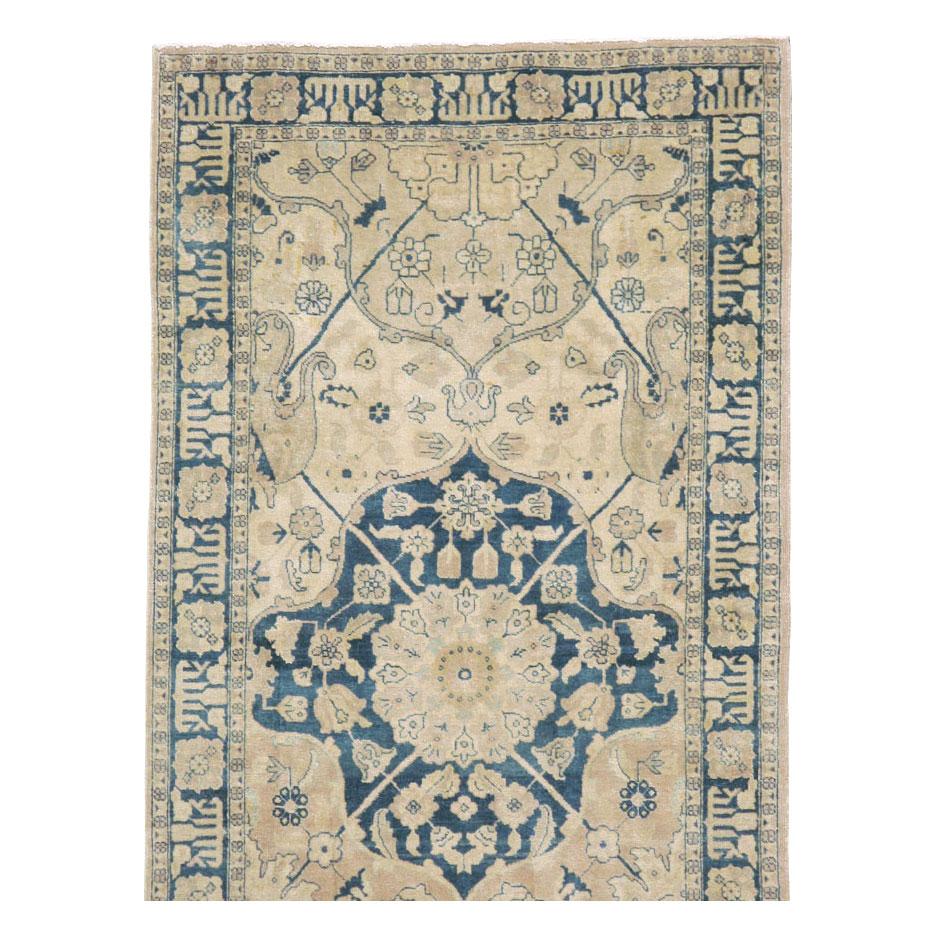 A vintage Persian Tabriz rug in runner format handmade during the mid-20th century.

Measures: 2' 9