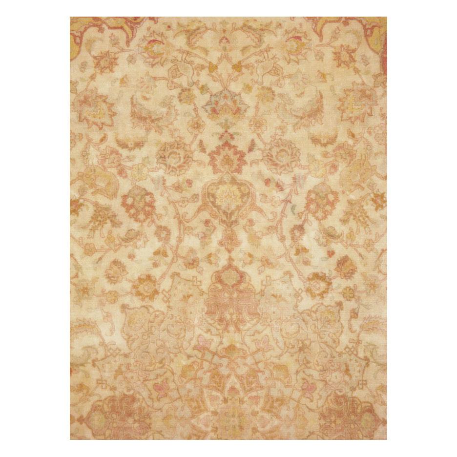 A vintage Persian Tabriz accent rug handmade during the mid-20th century with a traditional design consisting of an intricate large medallion and corner spandrels predominantly in cream and blonde tones.

Measures: 6'7