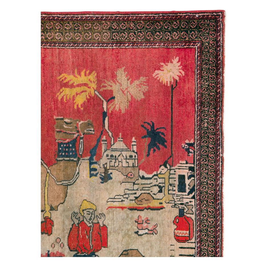 A vintage Persian pictorial accent rug handmade during the mid-20th century by the nomadic Afshar tribes of southeast Persia. The weaver must have been inspired by her tribal scenery and drew off of imagination. Camels used for their long pastures