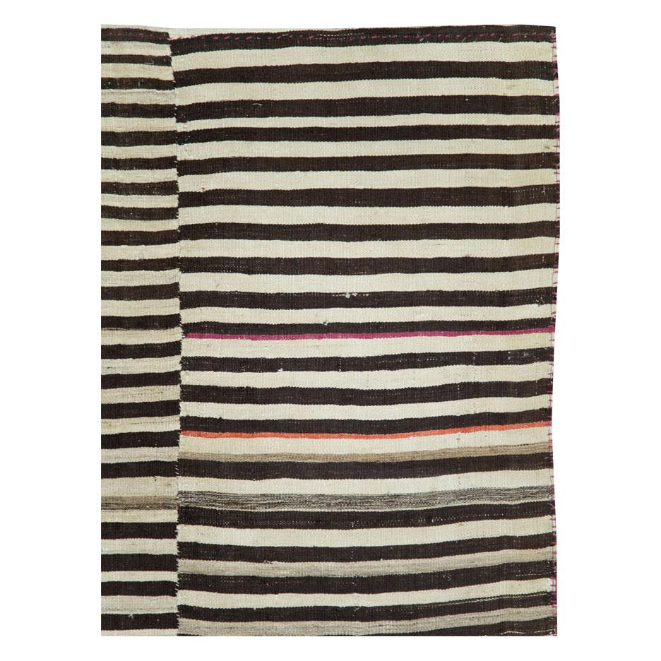 A vintage Persian flat-weave Kilim accent rug handmade during the mid-20th century with a tribal design resembling a zebra print in dark brown and black, and cream.

Measures: 6' 1