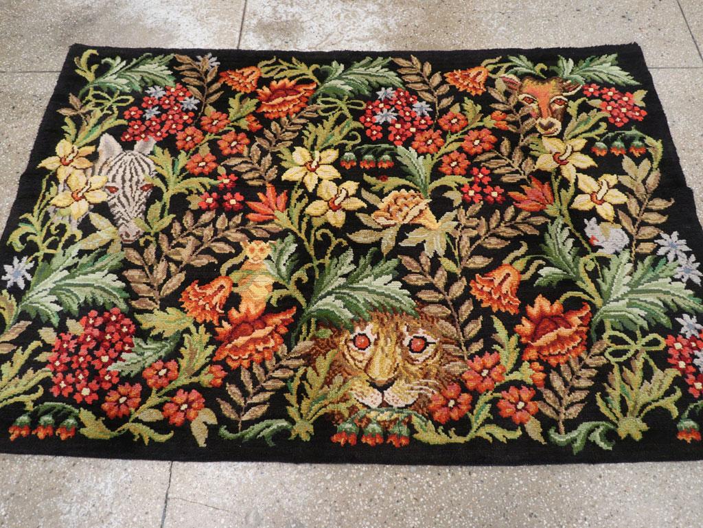 A vintage Portuguese piled accent rug handmade during the mid-20th century with a pictorial depiction of a jungle/forest setting including various plants and animals.

Measures: 4' 0