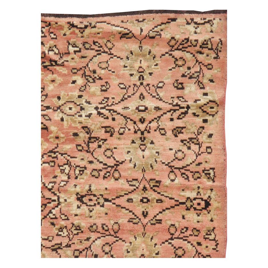 A vintage Turkish Anatolian accent rug in gallery format handmade during the mid-20th century in shades of dusty rose and blush pink.

Measures: 5' 0