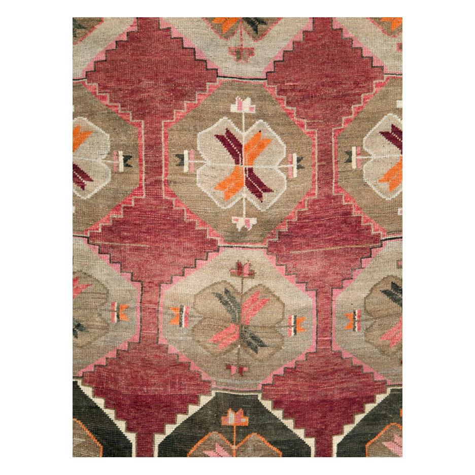 A vintage Turkish Anatolian room size rug in long and narrow gallery format handmade during the mid-20th century with a geometric tribal design.

Measures: 7' 1