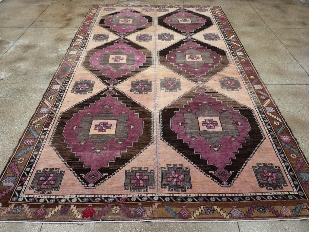 A vintage Turkish Anatolian long tribal room size carpet handmade during the mid-20th century.

Measures: 9' 0