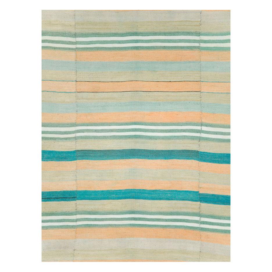 A vintage Turkish flatweave Kilim carpet in gallery format handmade during the mid-20th century with a striped pattern in pastel colors.

Measures: 6' 5