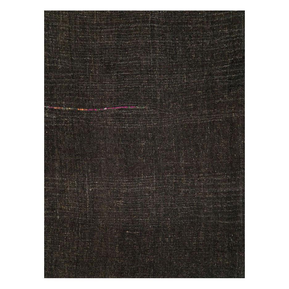 A vintage Turkish flatweave Kilim gallery carpet handmade during the mid-20th century in shades of black and dark brown.

Measures: 5' 11