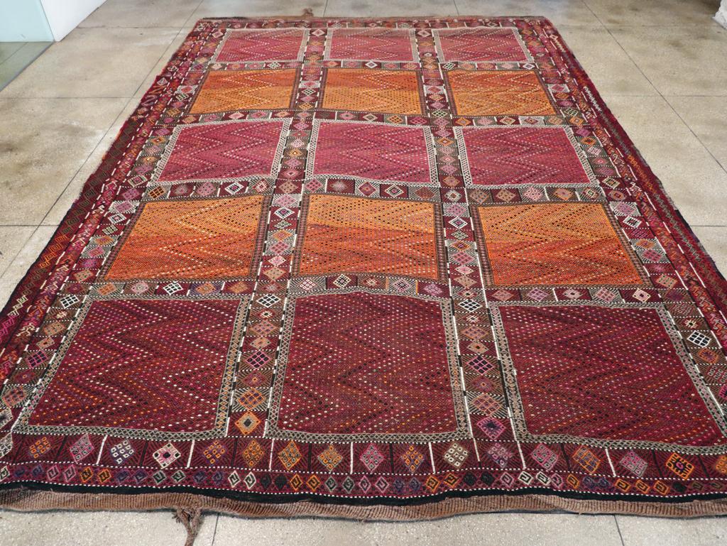 A vintage Turkish flatweave Kilim large tribal carpet handmade during the mid-20th century.

Measures: 12' 4