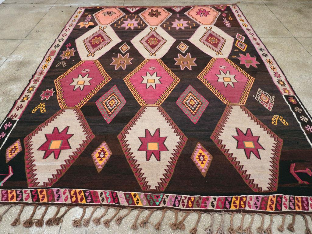 A vintage Turkish tribal flatweave Kilim room size carpet handmade during the mid-20th century.

Measures: 10' 7
