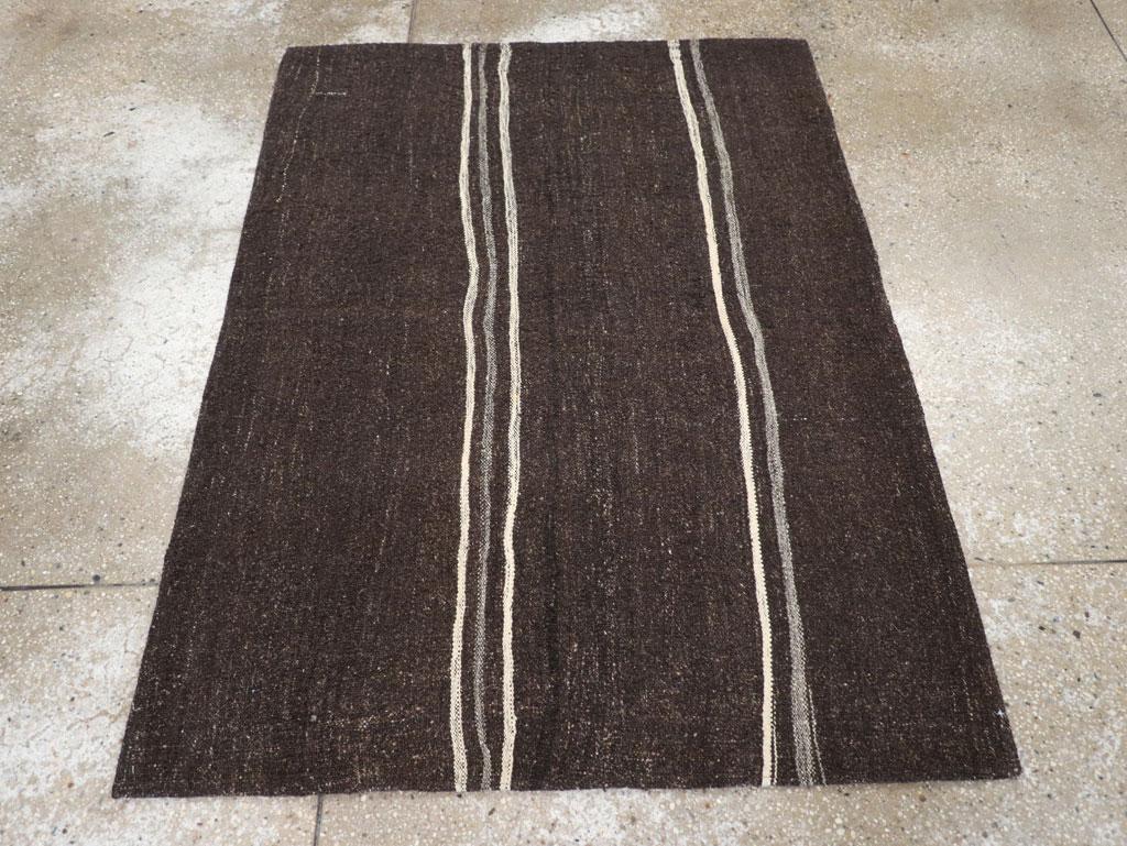 A vintage Turkish flatweave Kilim throw rug handmade during the mid-20th century in shades of brown-black (reads black) and cream.

Measures: 3' 6