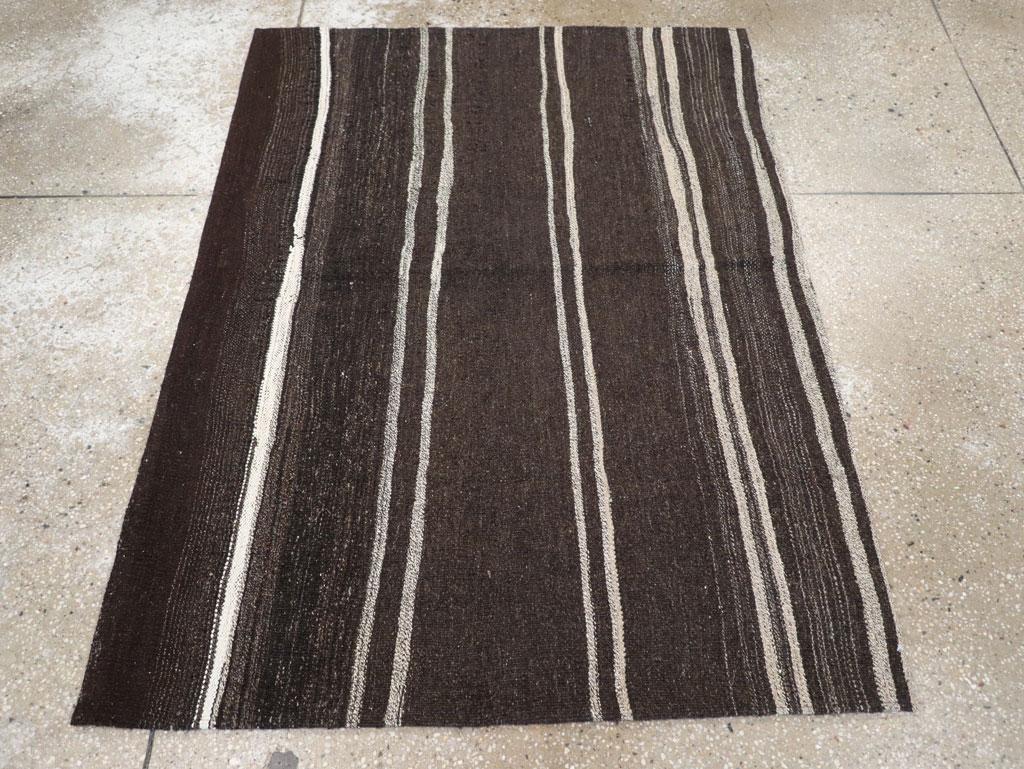 A vintage Turkish flatweave Kilim throw rug handmade during the mid-20th century in shades of brown-black (reads black) and cream.

Measures: 3' 7
