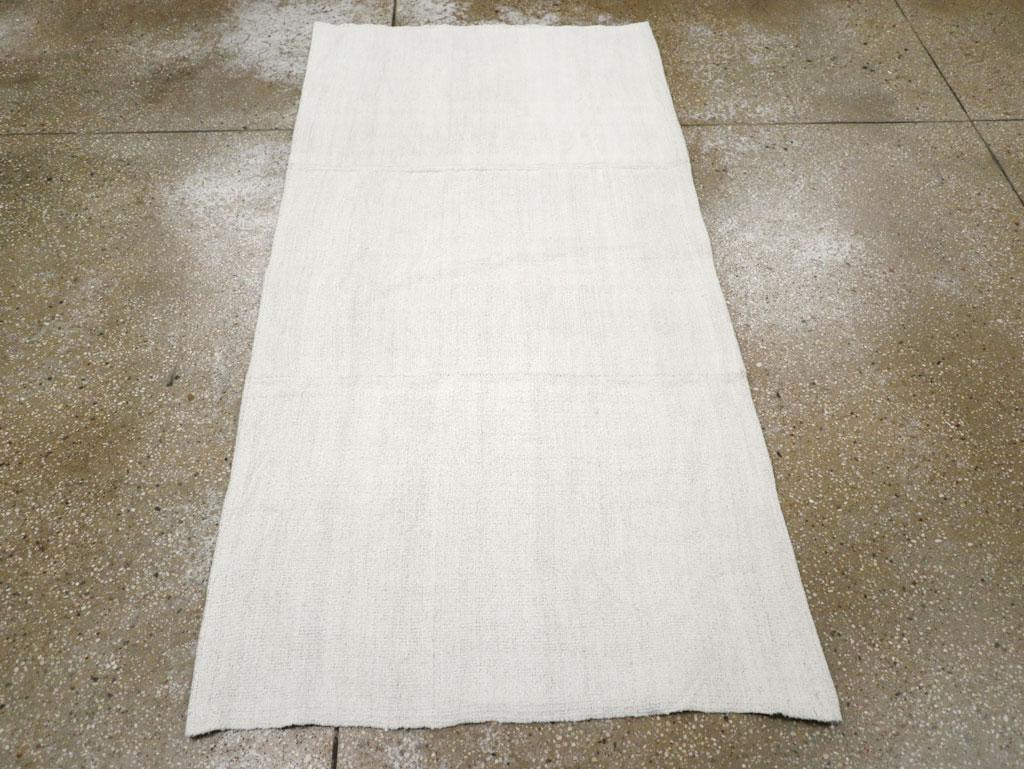 A vintage Turkish flatweave Kilim throw rug handmade during the mid-20th century in white.

Measures: 3' 0