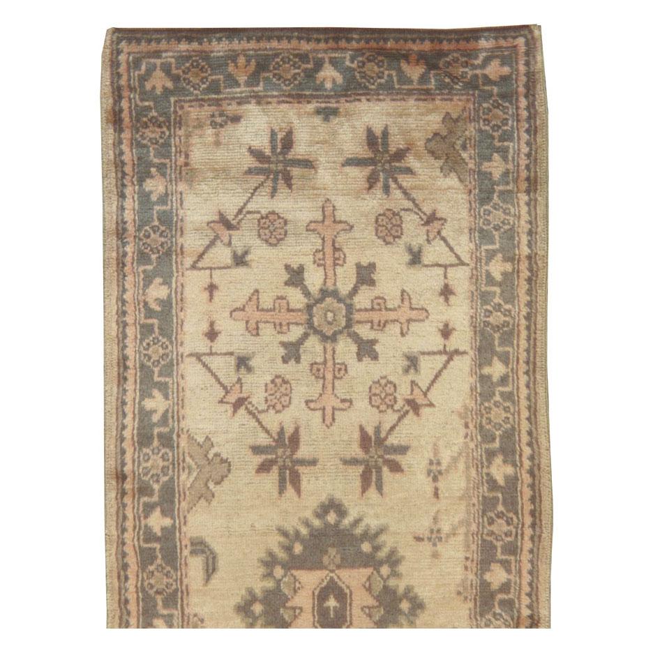 A vintage Turkish Oushak rug in runner format handmade during the mid-20th century.

Measures: 3' 1