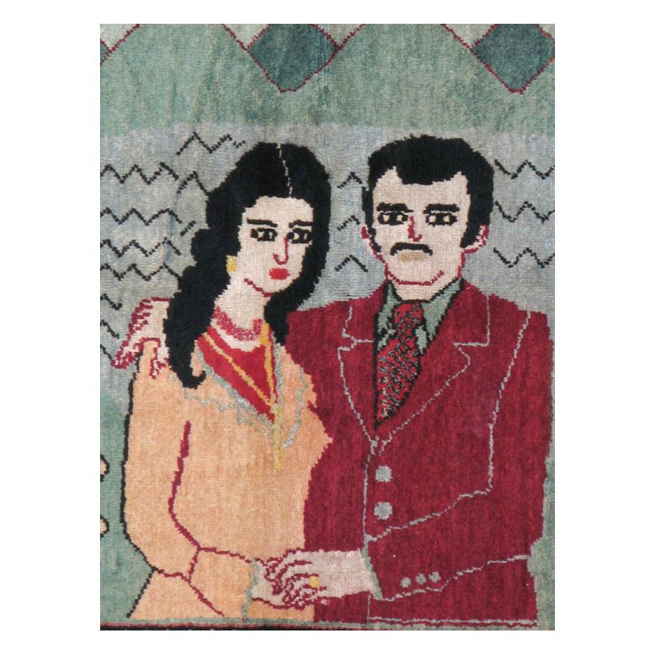 A vintage Turkish Sivas accent rug handmade during the mid-20th century with a pictorial design of a couple over a mountainous landscape.

Measures: 4' 6