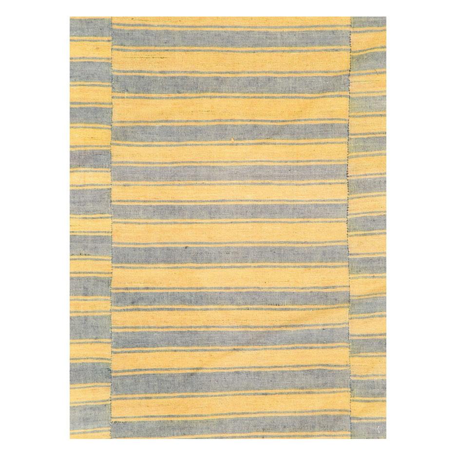A vintage Turkish flat-weave Kilim accent rug handmade during the mid-20th century with a striped design offset on 3 stitched panels.

Measures: 6' 0