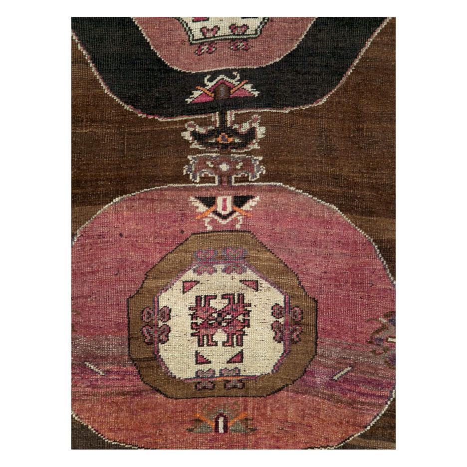 A vintage Turkish Anatolian accent rug in gallery format with a tribal aesthetic handmade during the mid-20th century.

Measures: 5' 5