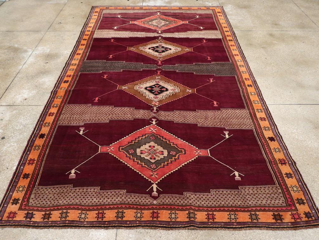 A vintage Turkish Anatolian tribal room size carpet, in long and narrow format, handmade during the mid-20th century.

Measures: 7' 9