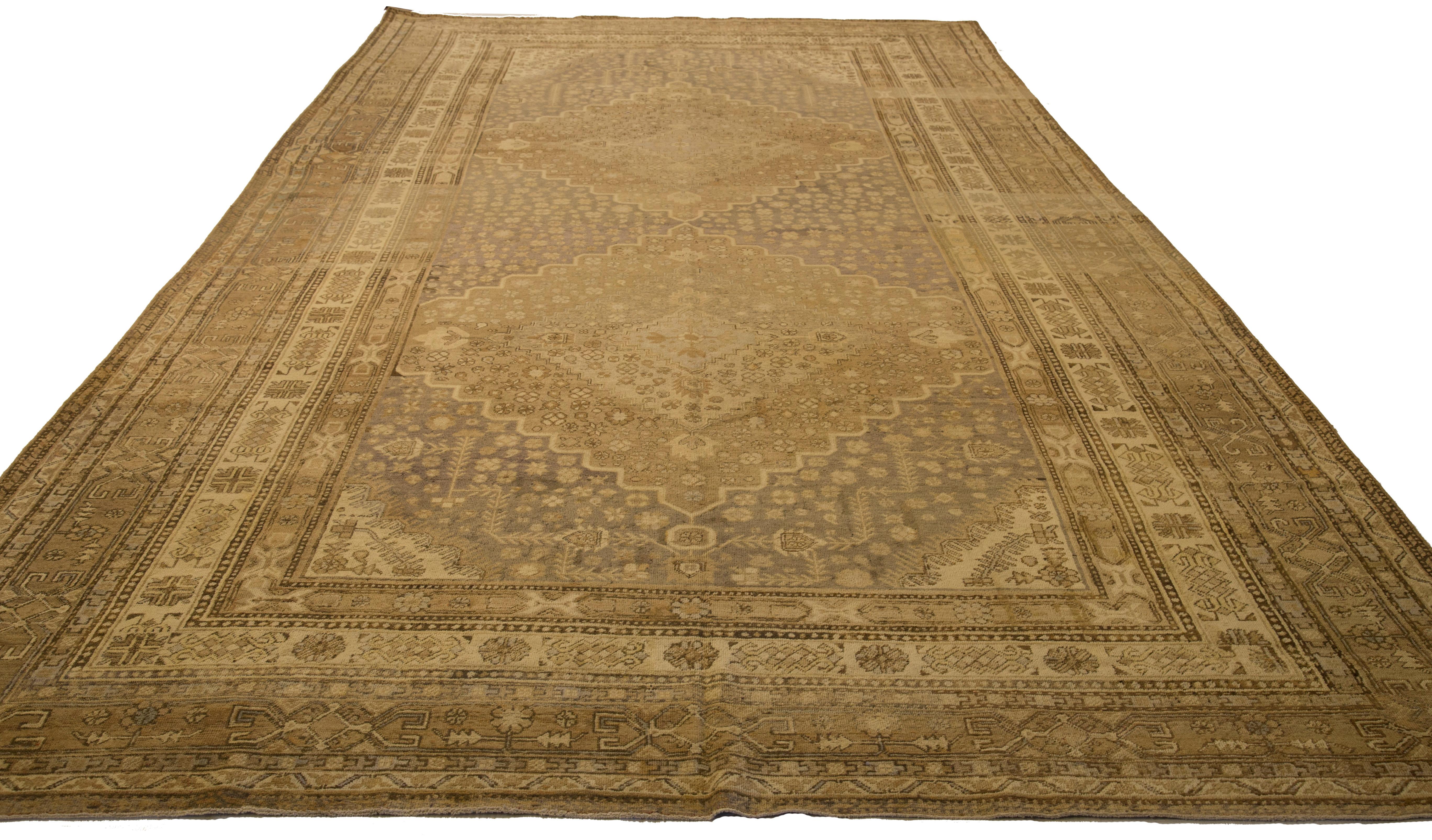 Mid-20th century hand-woven Persian area rug made from fine wool and all-natural vegetable dyes that are safe for people and pets. It features traditional Khotan weaving depicting intricate floral and botanical patterns. 

This area rug has